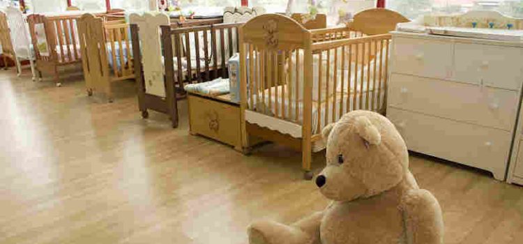 empty nursery with teddy bear on floor